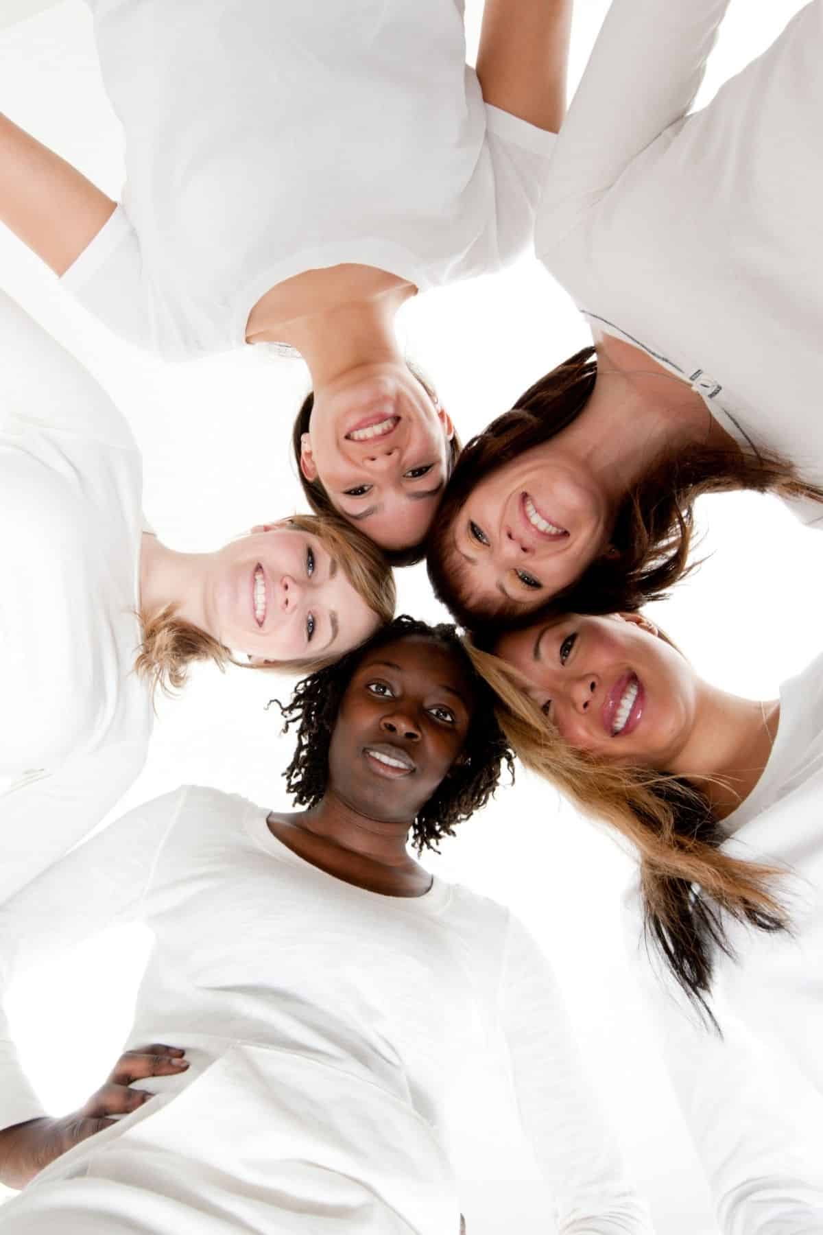 five women looking down and smiling.