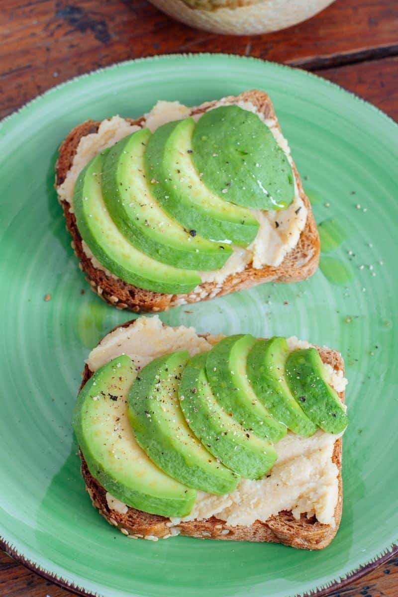Avocado sandwich on toast with oil drizzle.