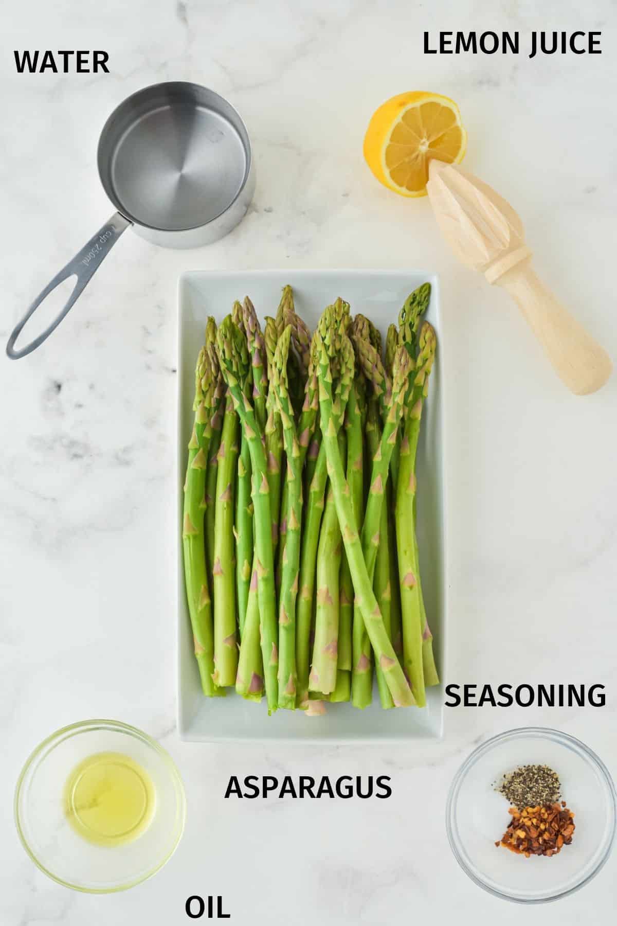 Ingredients to make Instant Pot asparagus on a white surface.