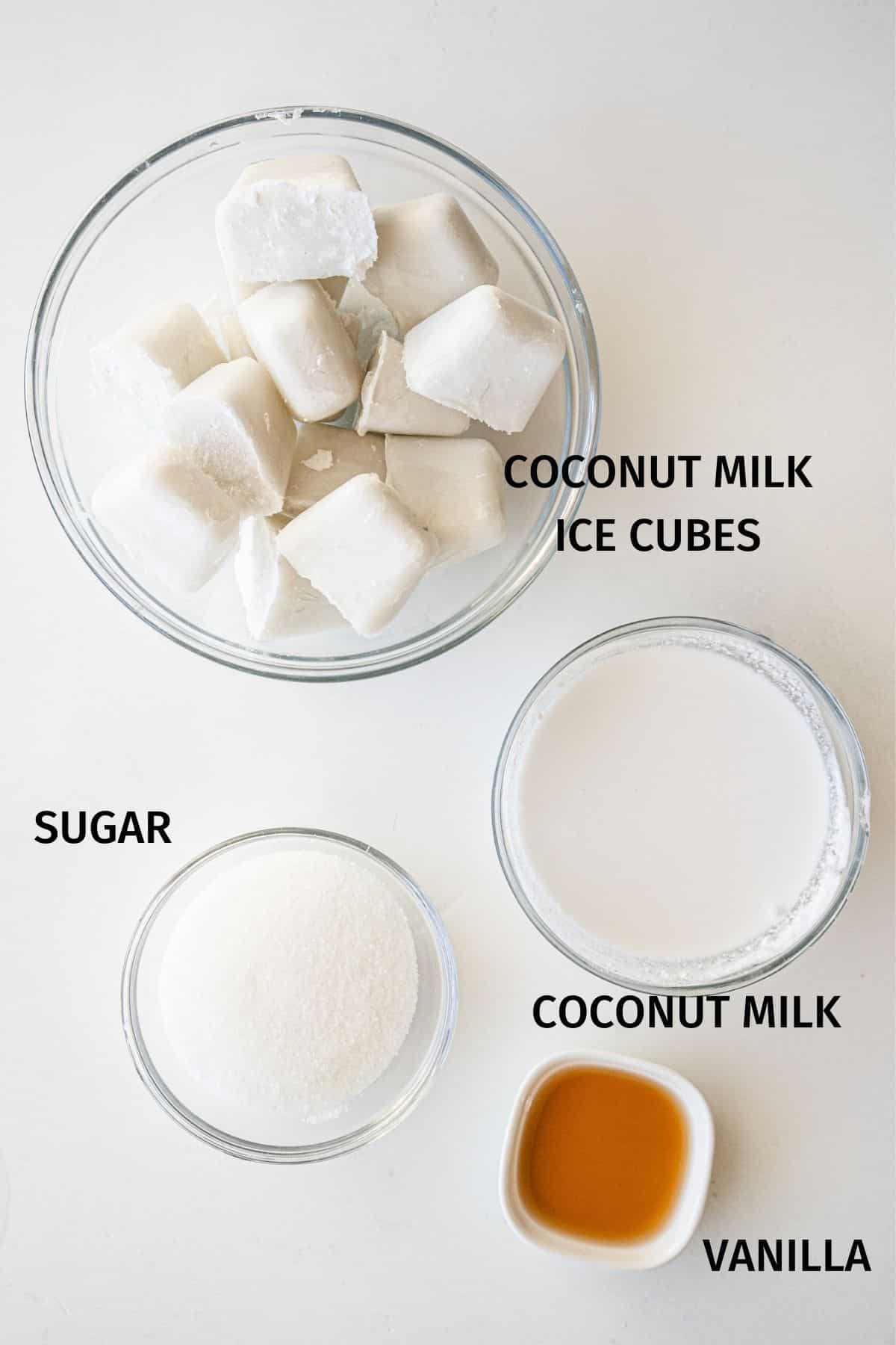 Vitamix Vanilla Ice Cream ingredients in small bowls on a white surface.