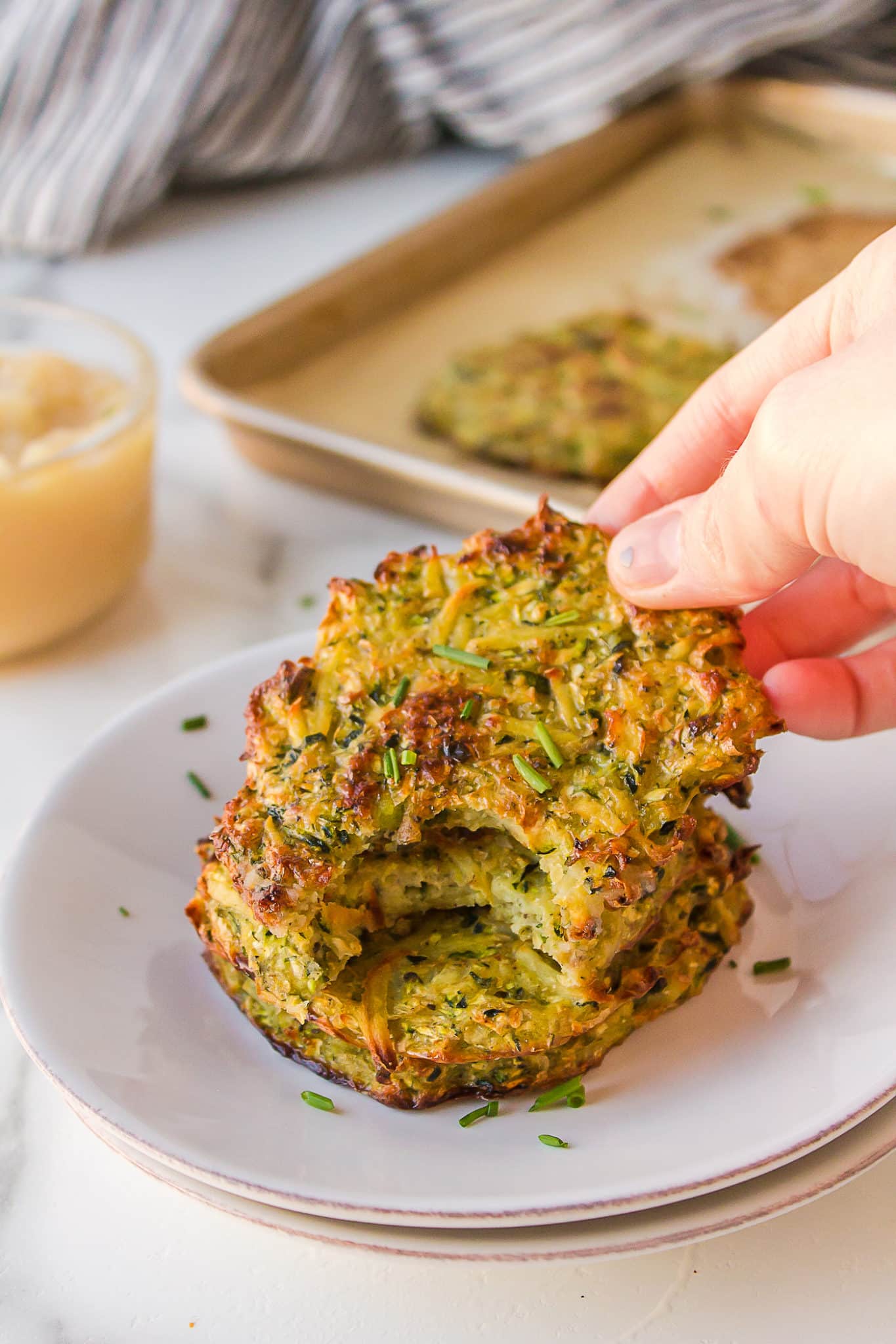 hand holding a zucchini fritter