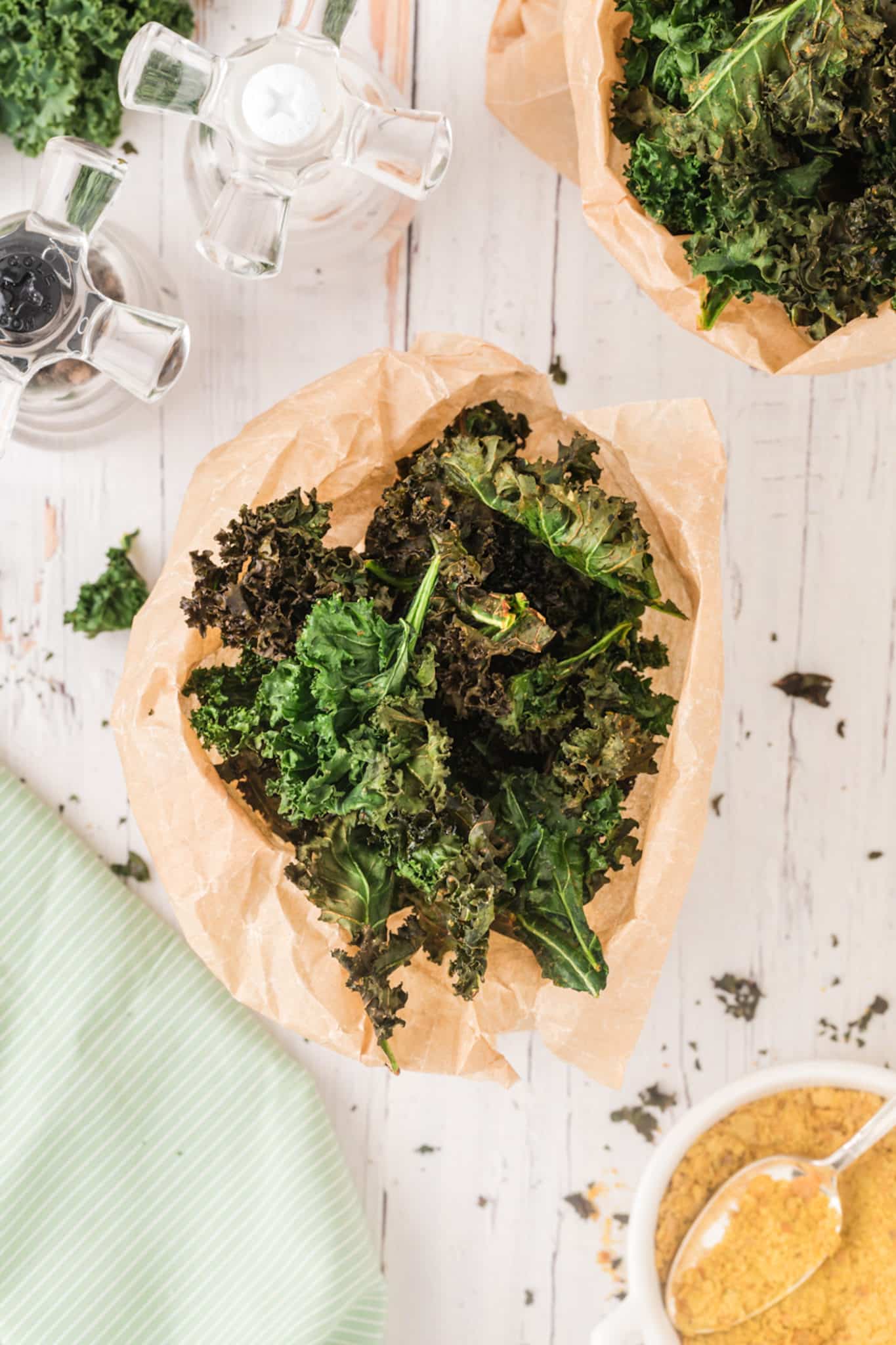 overhead shot of cooked kale chips in two bags.