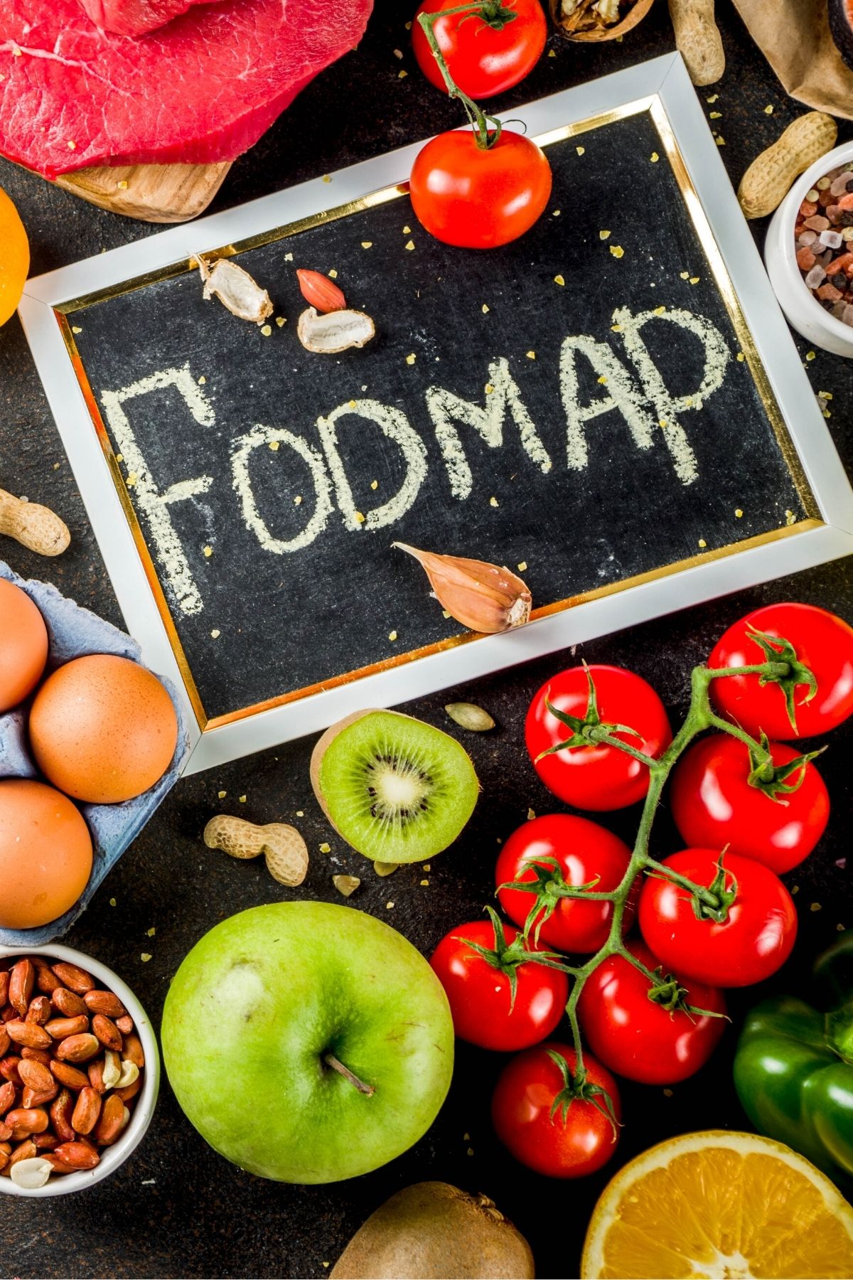 fodmap diet on blackboard on table with foods.