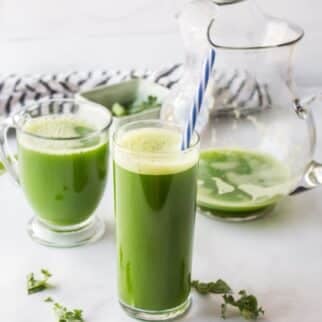 glass of green juice on table.