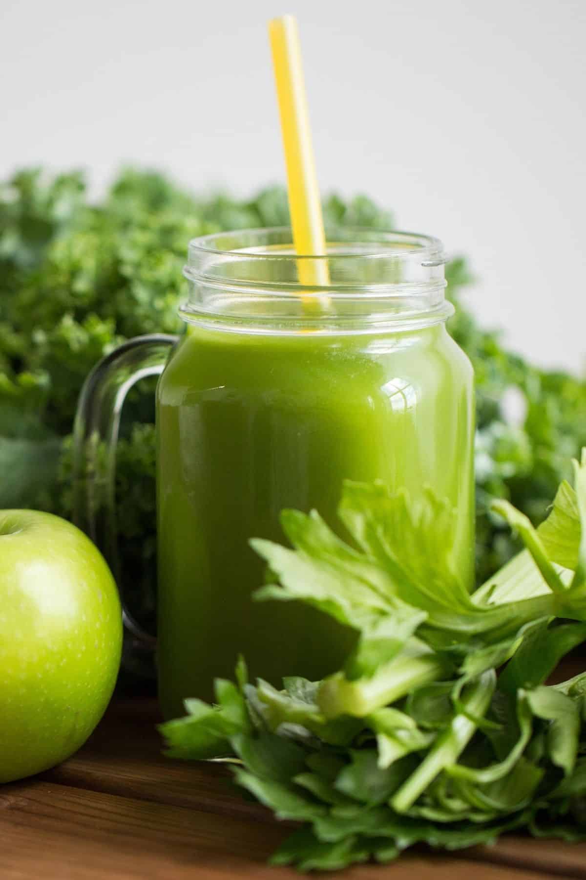 green detox juice in jar on table.