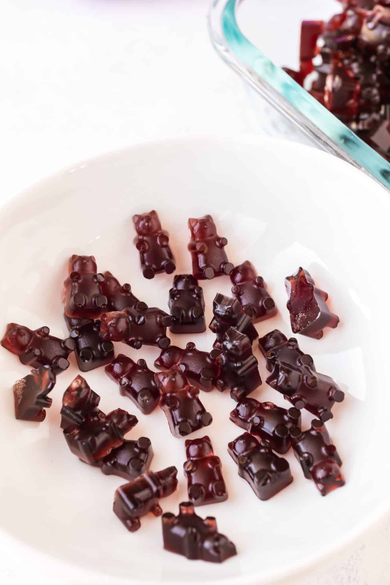 pomegranate gummy bears served on a white plate.