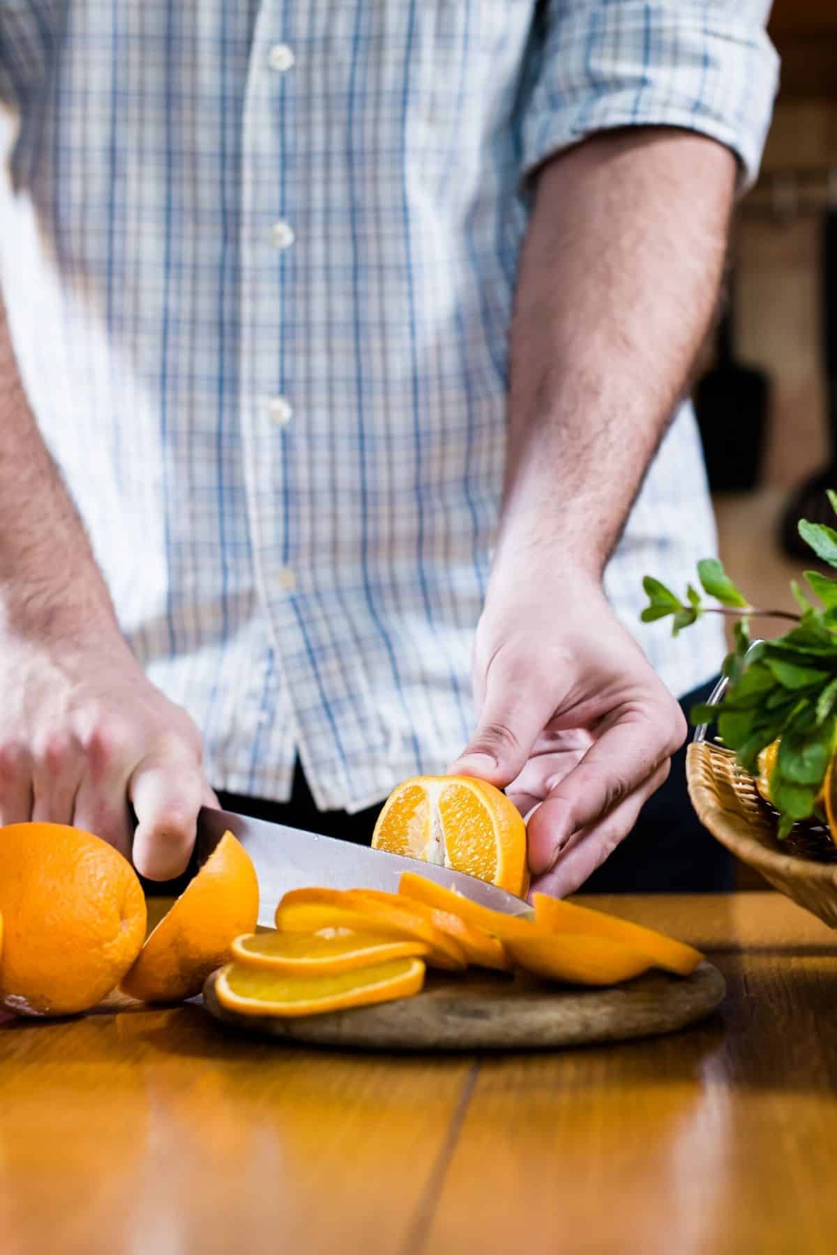 man cutting an orange.