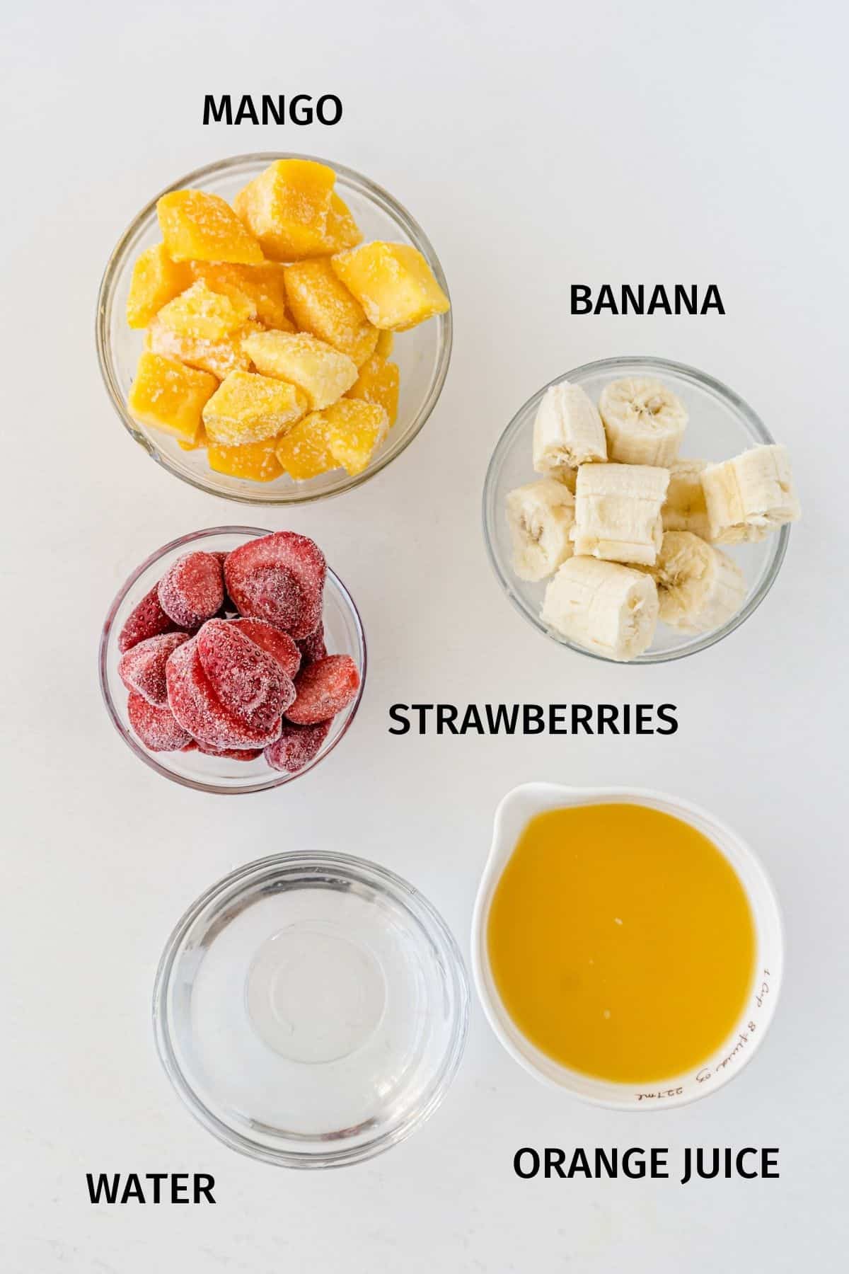 ingredients for a mango strawberry smoothie.