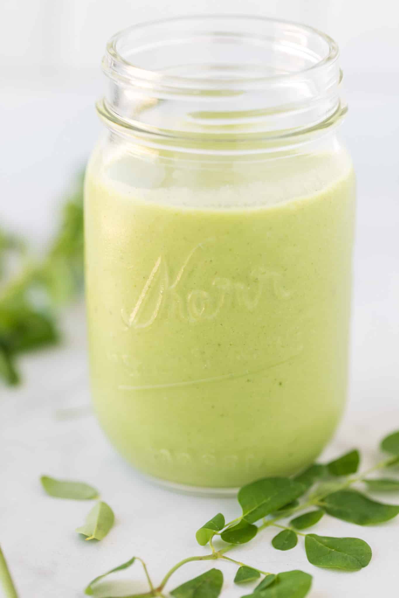 Moringa smoothie in a large glass jar.
