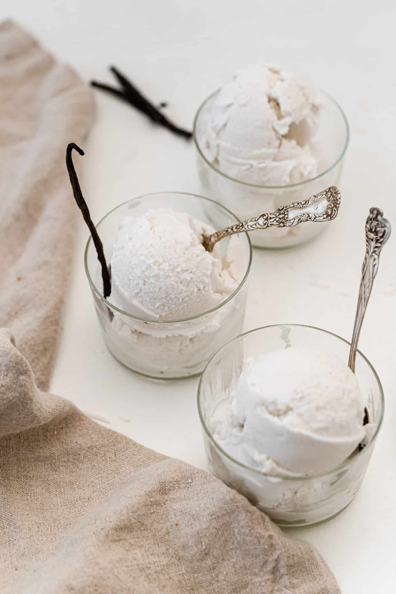 Three small glass bowls of no-churn vanilla ice cream.