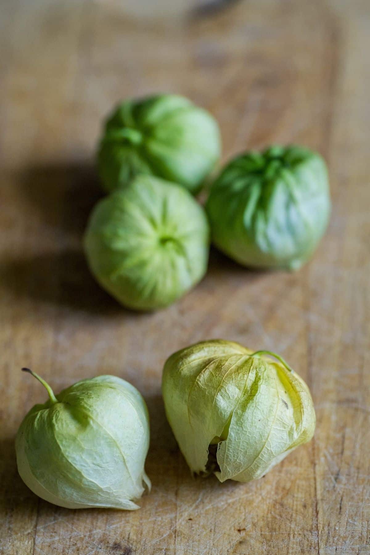 tomatillos on a wooden countertop.