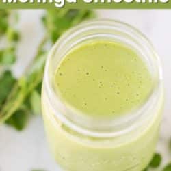 Vegan Moringa Smoothie in a glass jar on a white surface.