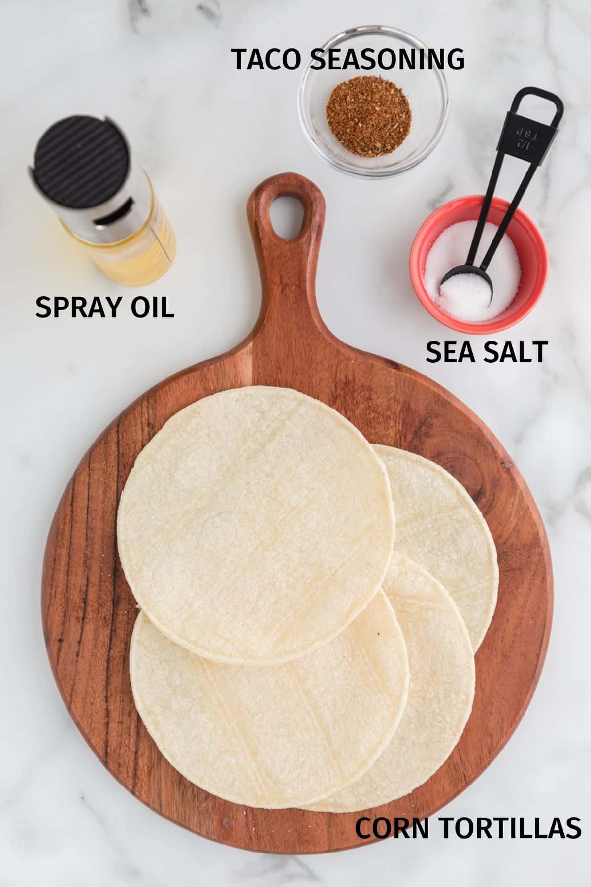 Tortillas, oil, and seasoning on a white surface.