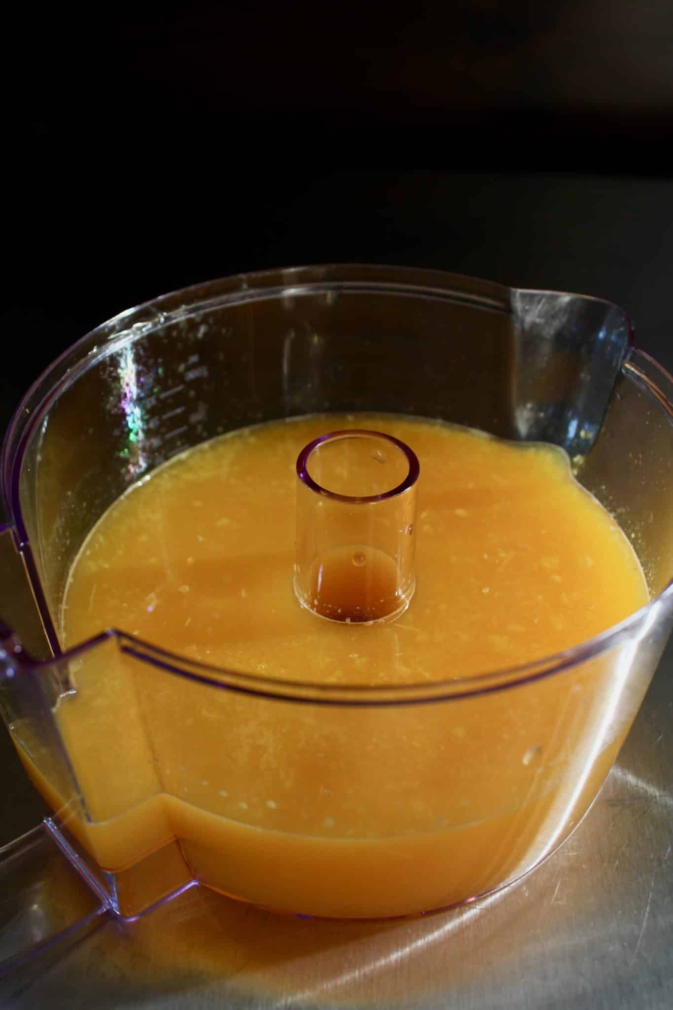 freshly squeezed orange juice in a juicer.