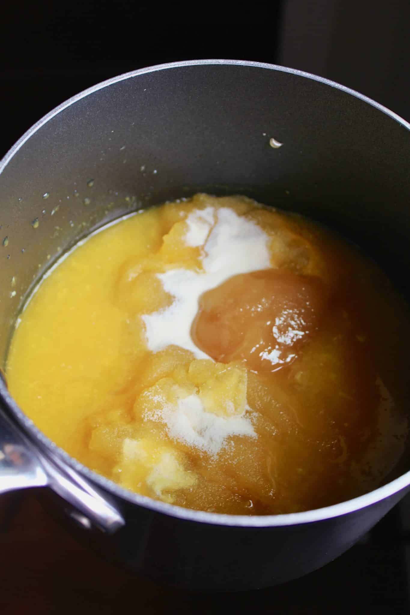 saucepan with ingredients for making homemade orange jello.
