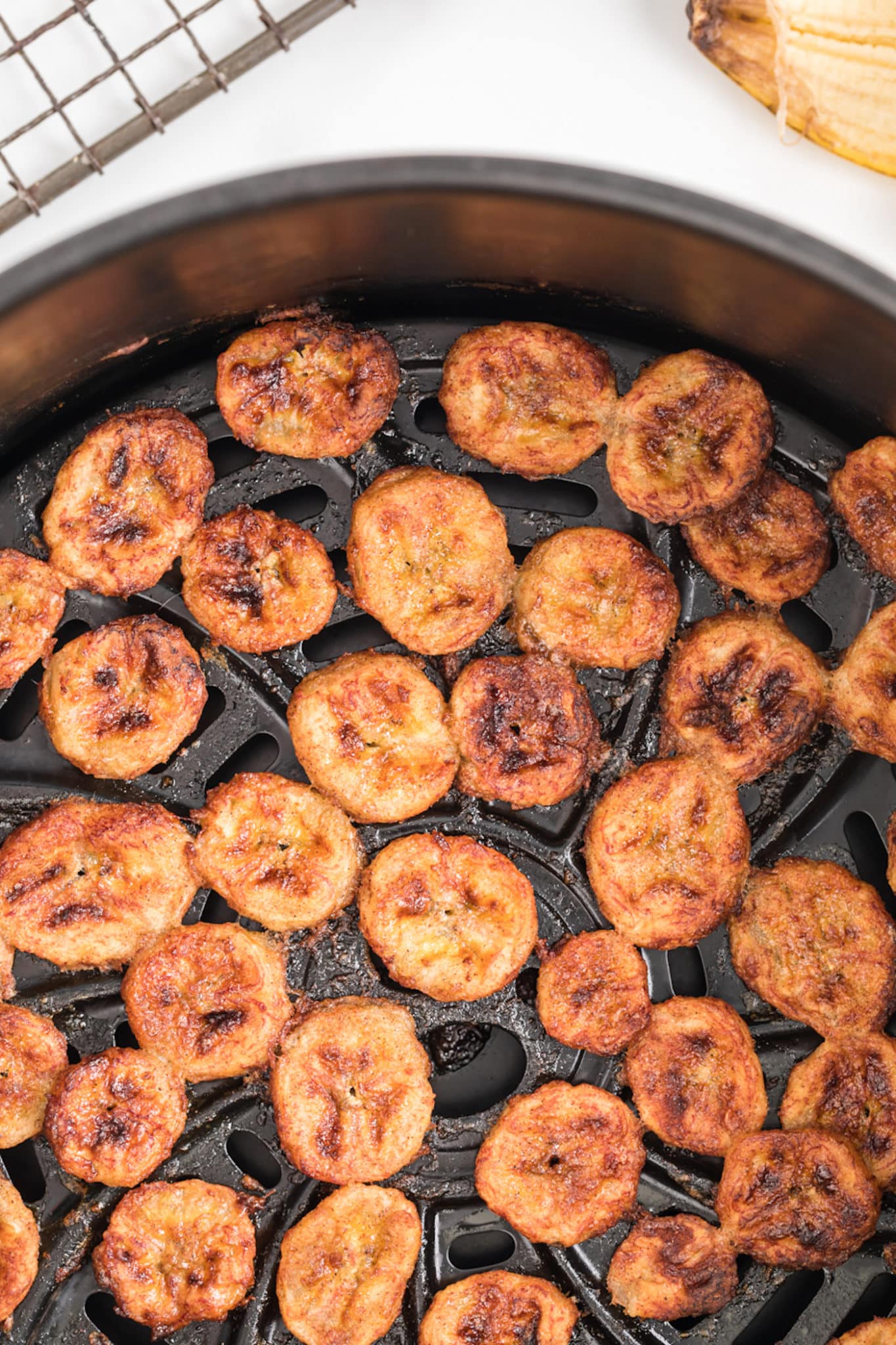 air fryer crispy banana chips inside the basket.