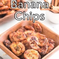 A wooden square bowl with freshly air fried cinnamon banana chips.