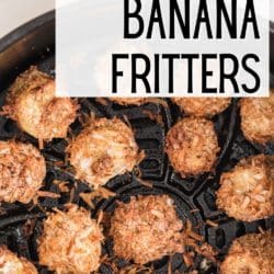 Cooked banana fritters in an air fryer basket.