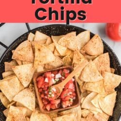 A large bowl of air fryer tortilla chips with a small bowl of fresh salsa.
