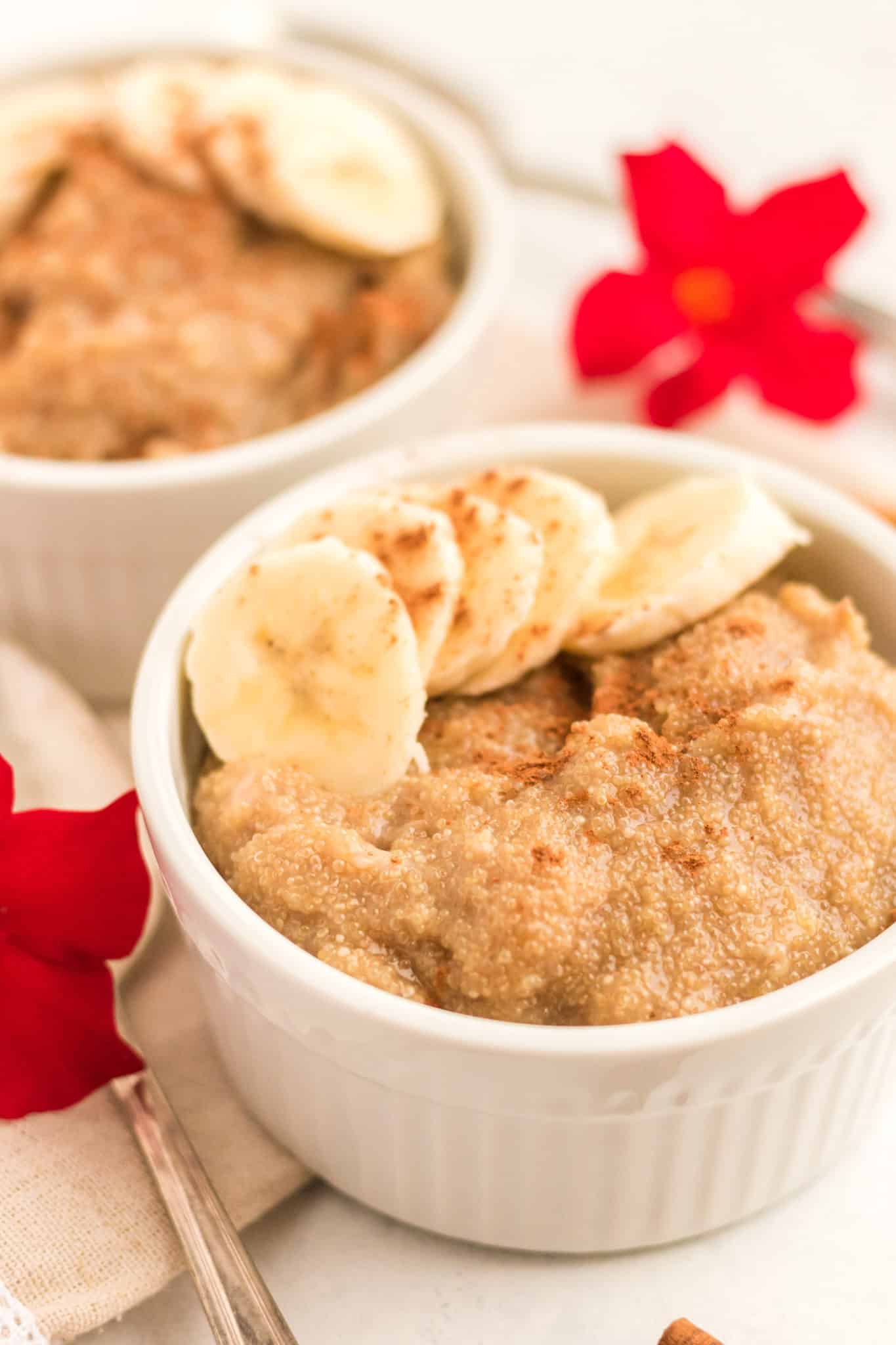 bowl of creamy amaranth porridge with sliced banana and cinnamon.