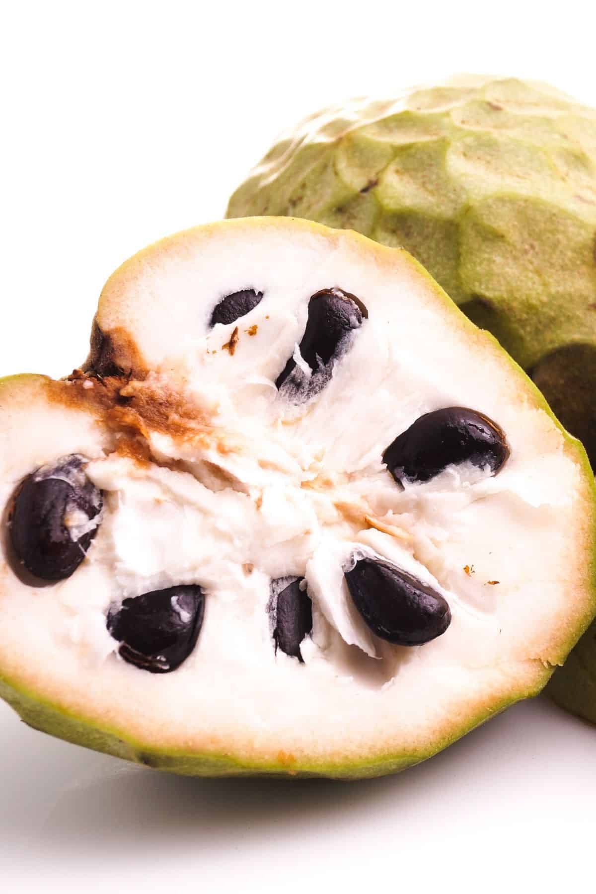 cherimoya cut in half on table.