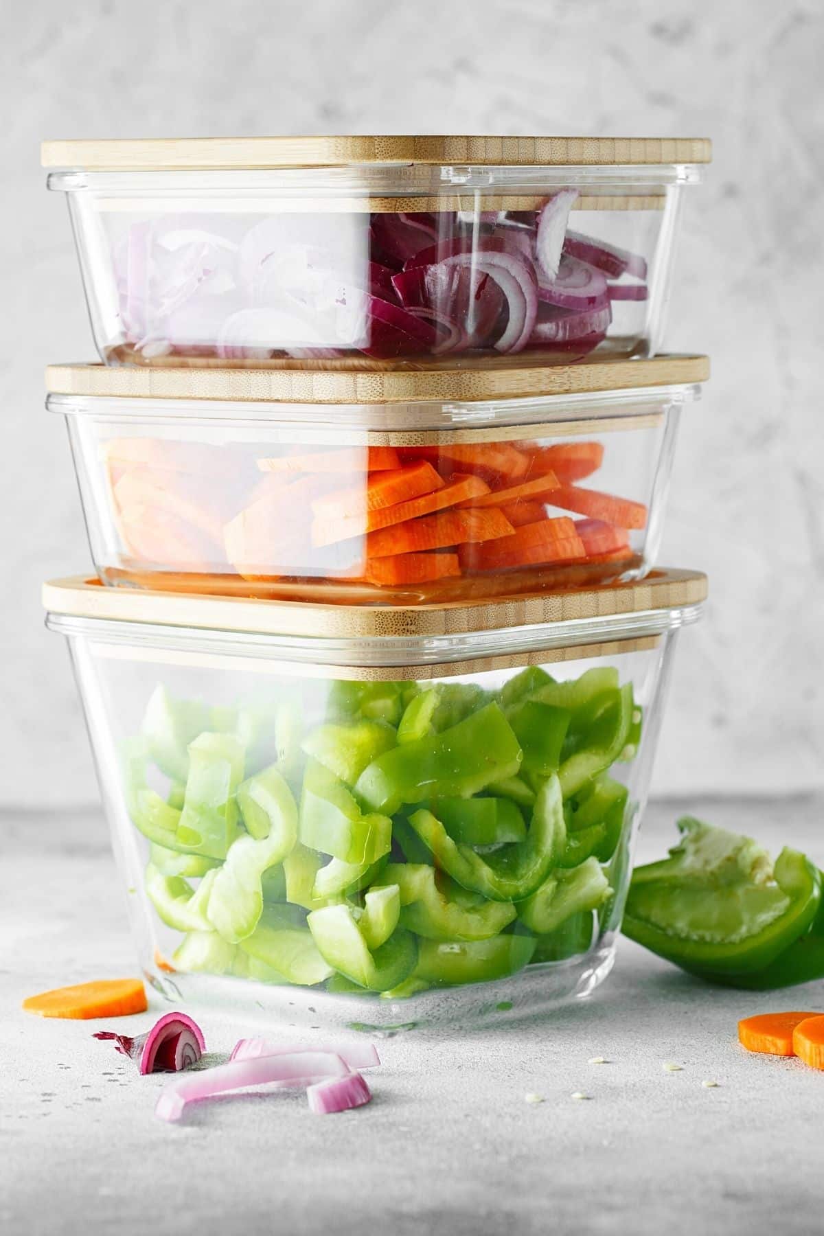 chopped vegetables in square glass containers.
