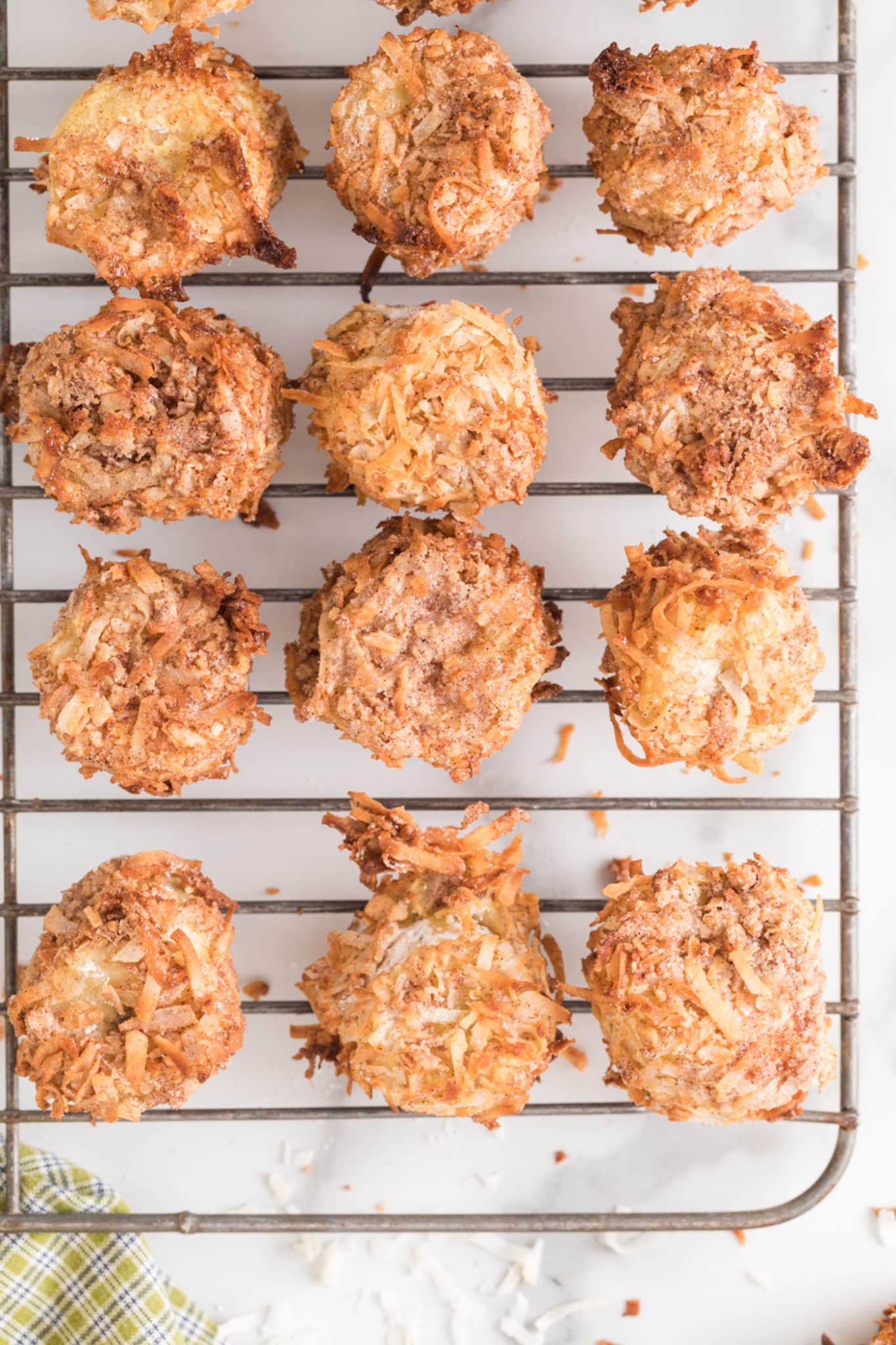 Cooked banana fritters on a wire cooling rack.