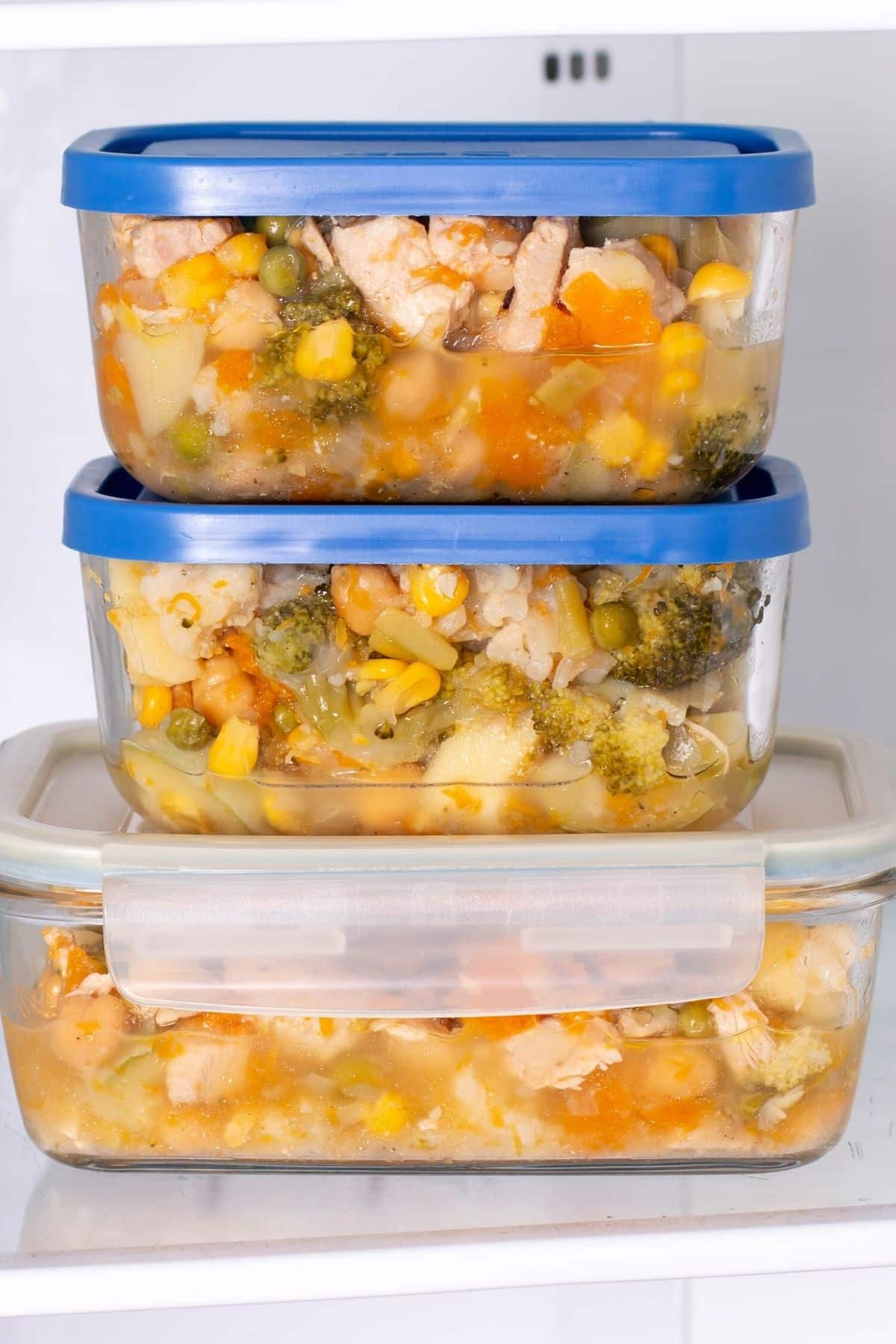 leftover soup in containers in fridge.