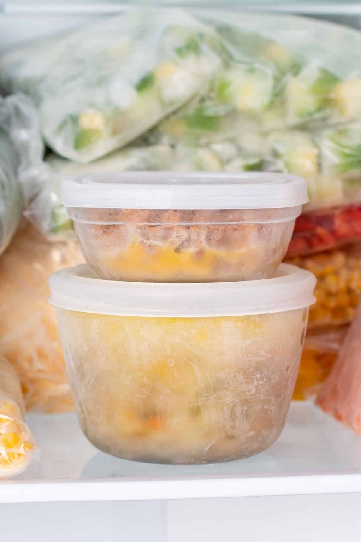 two containers in a freezer.