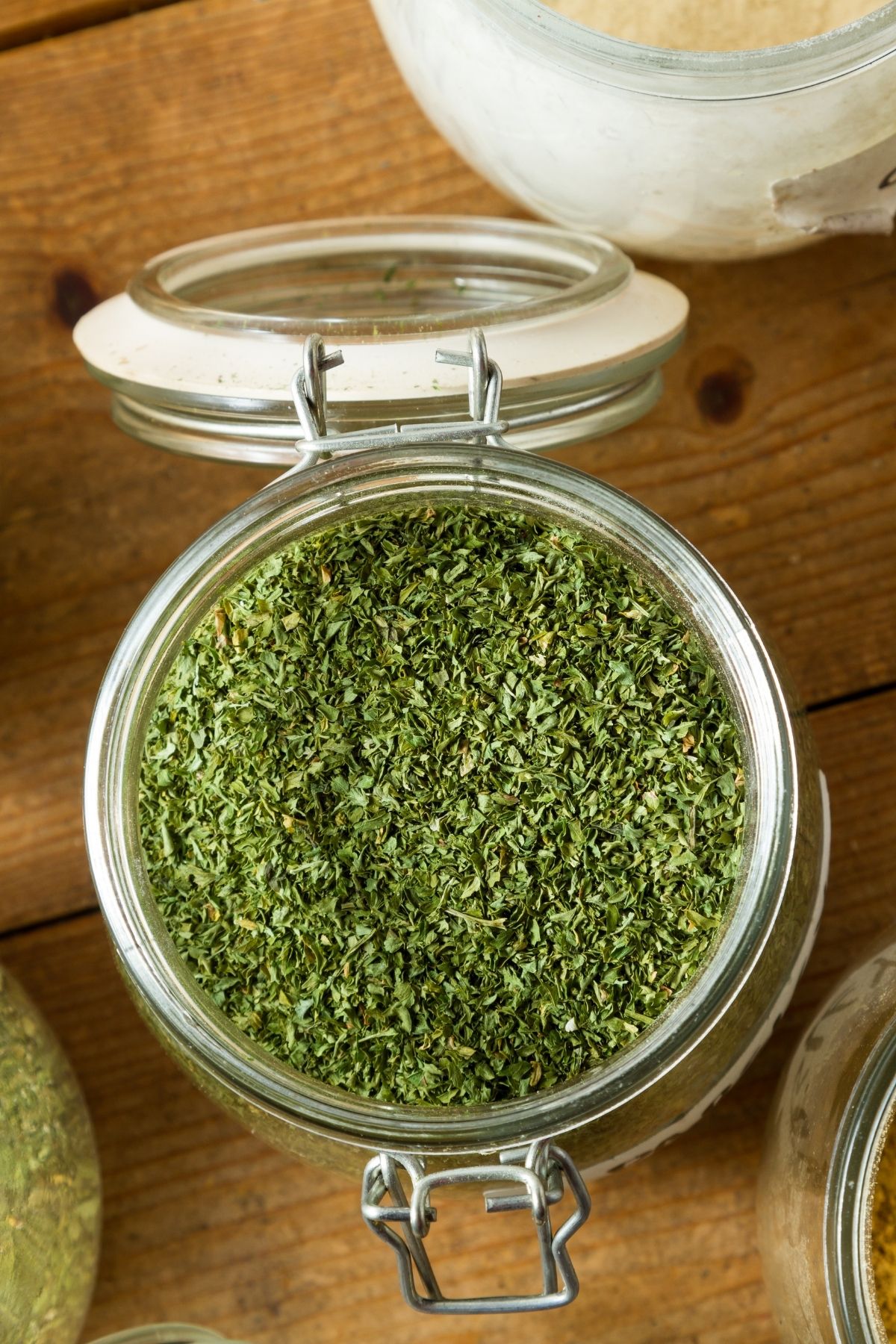 A jar with dried Italian seasoning inside.