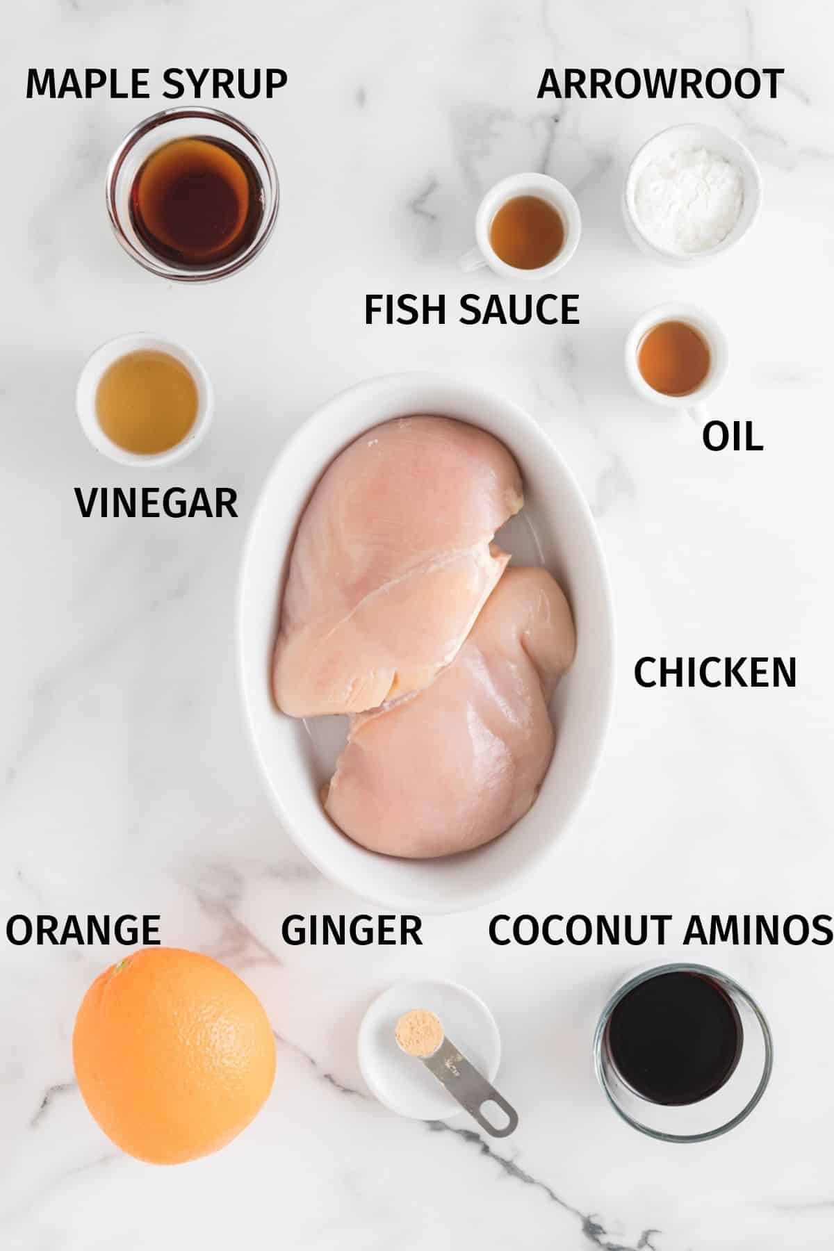 Ingredients for Air Fryer Orange Chicken in small bowls on a white surface.