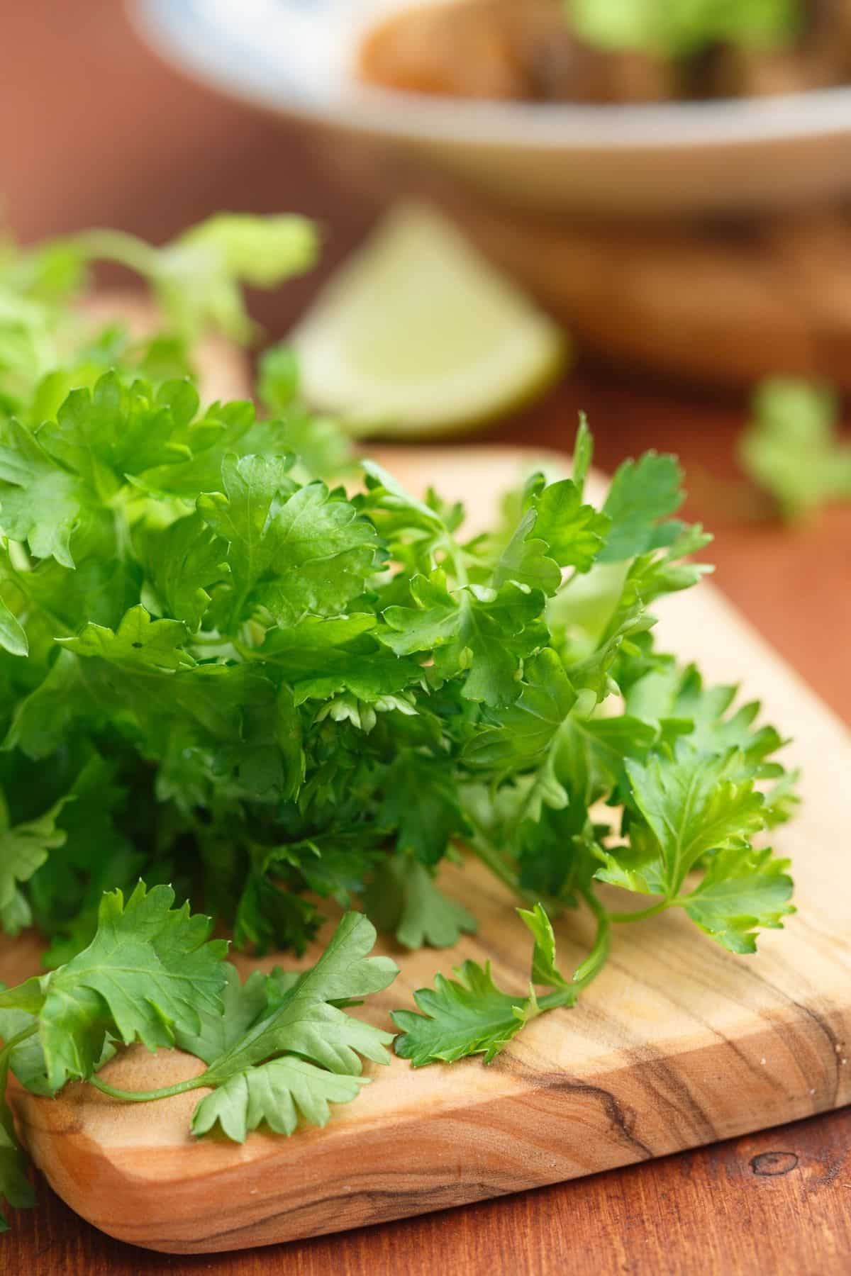 Fresh parsley on a wooden cutting board.