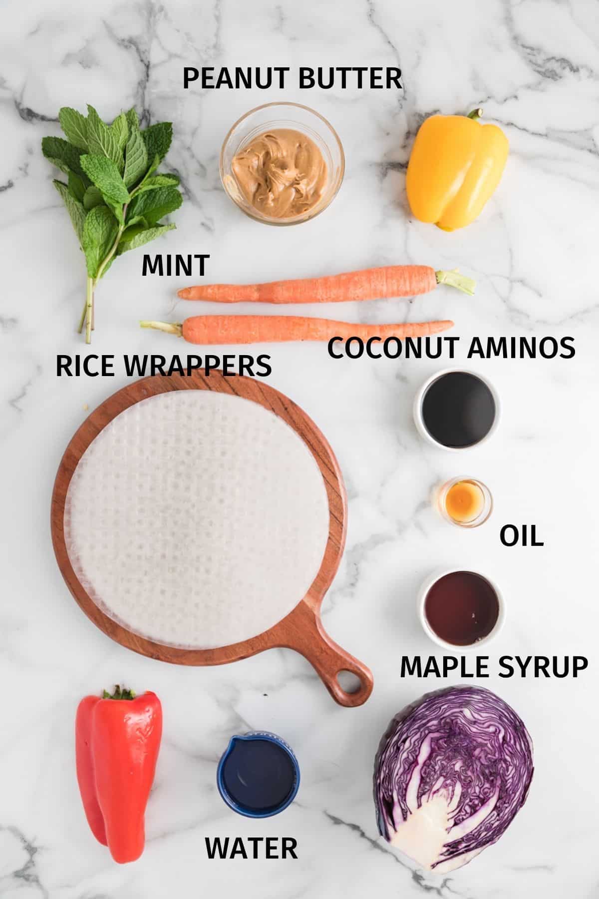 Ingredients for making summer rolls on a white surface.