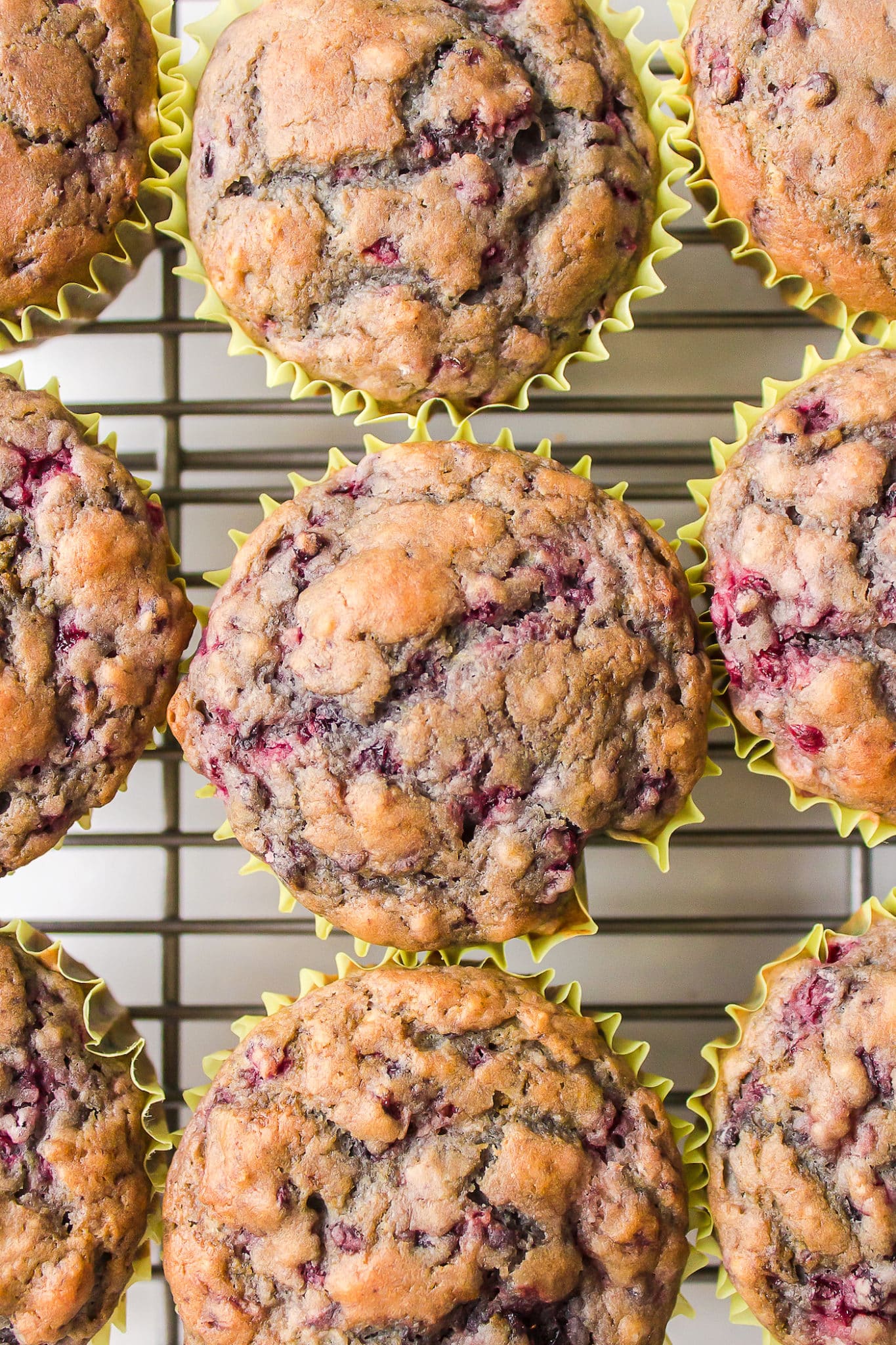 Top down shot of gluten-free blackberry muffins on a metal cooling rack.