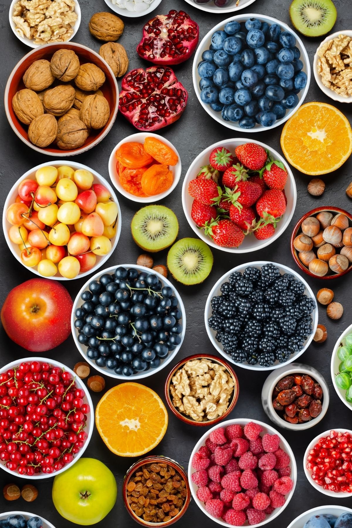 Bowls of different types of fruit and nuts.