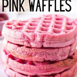 A stack of four pink waffles on a white plate.