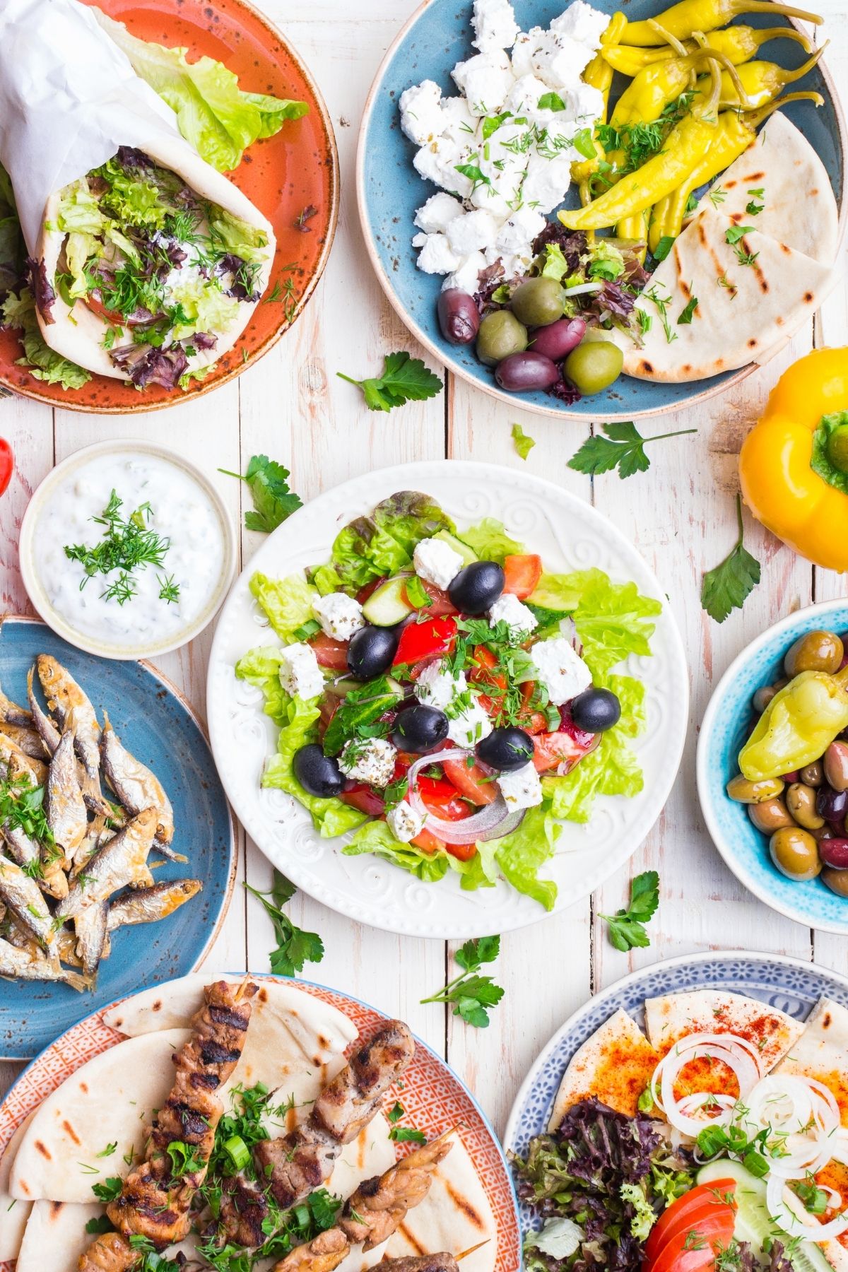 Plates of Mediterranean salads, olives, cheese and pita bread. 