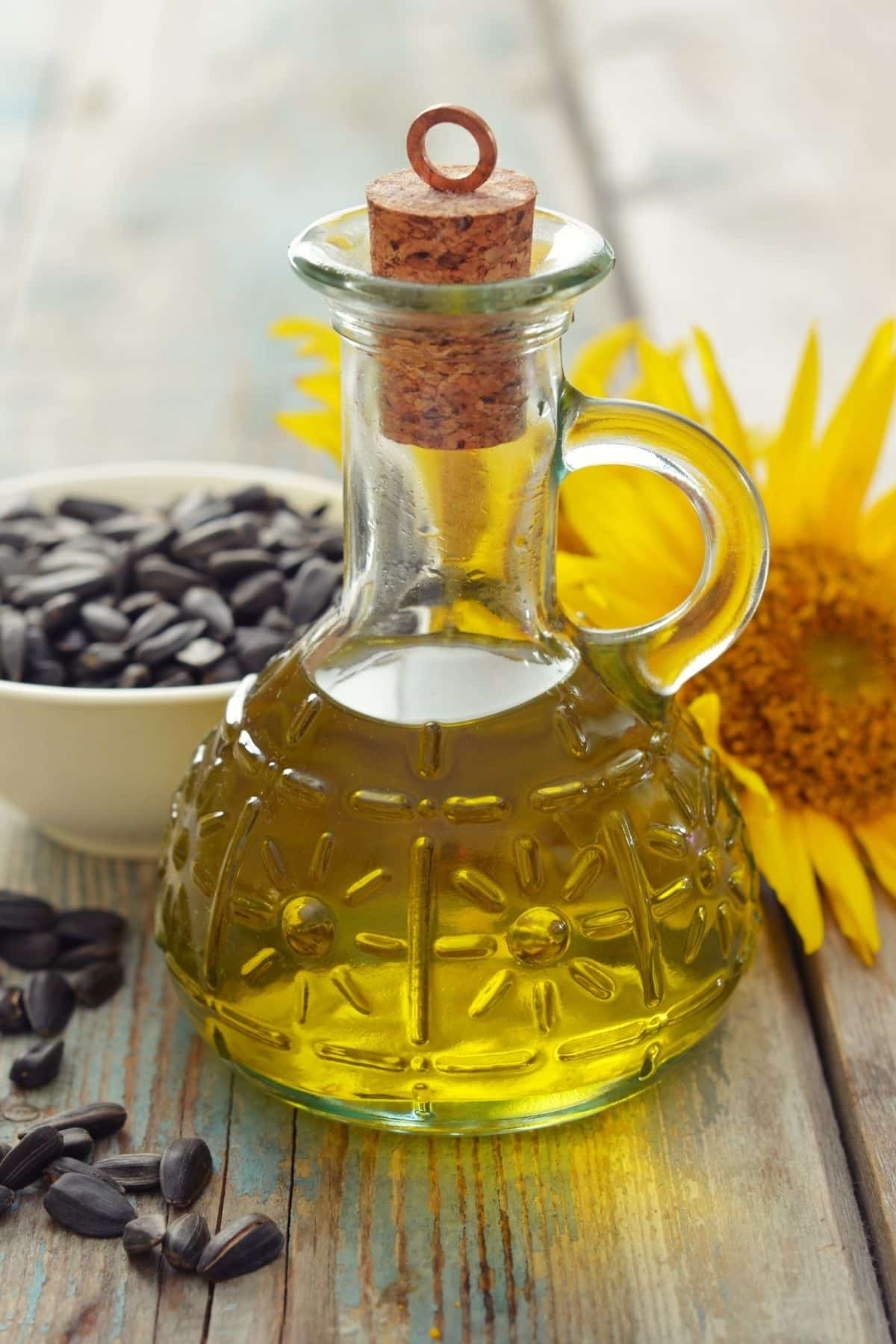 Jar of sunflower oil on a wooden counter.