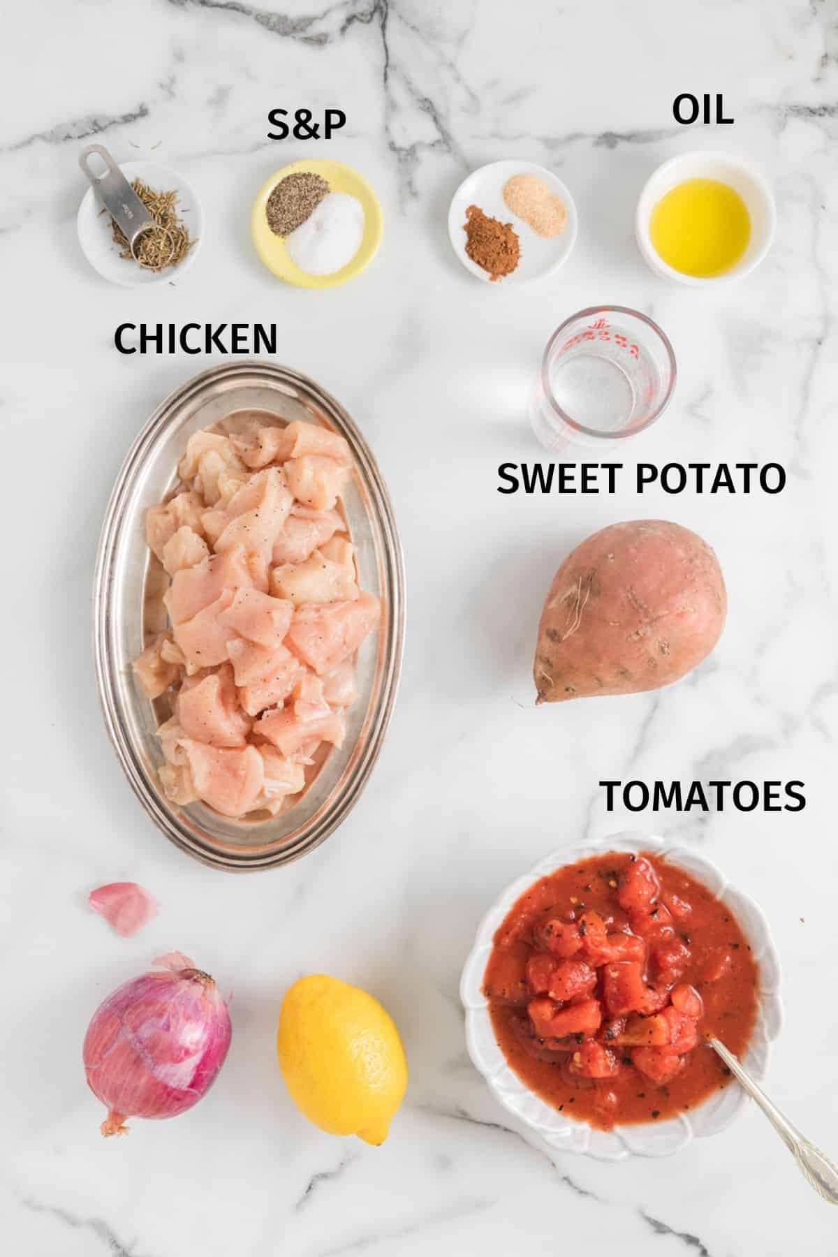 Ingredients for Sweet Potato Chicken in small bowls on a white surface.