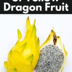 A large yellow dragonfruit cut in half on a white surface.