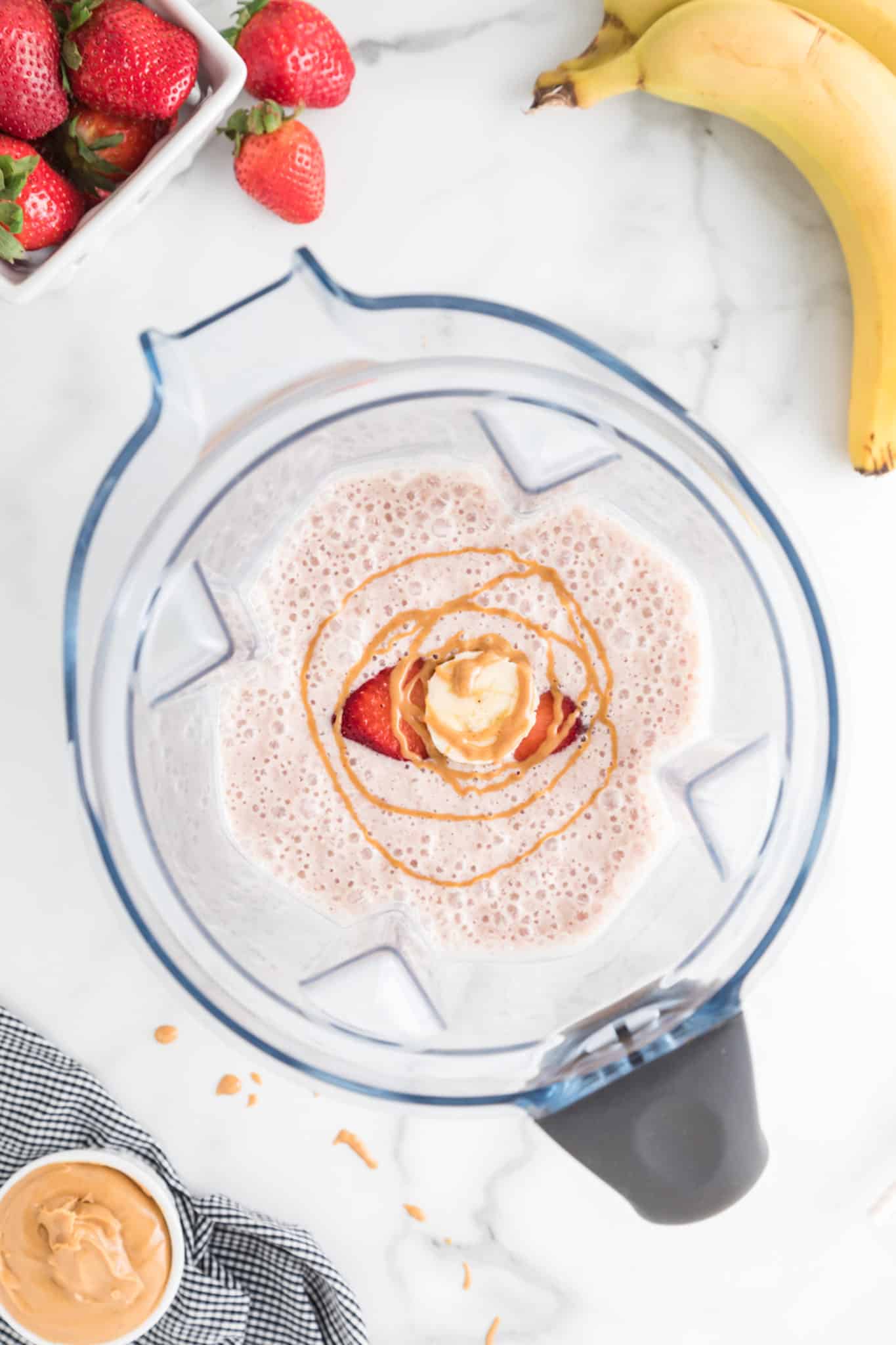 blended strawberry banana peanut butter smoothie in blender.