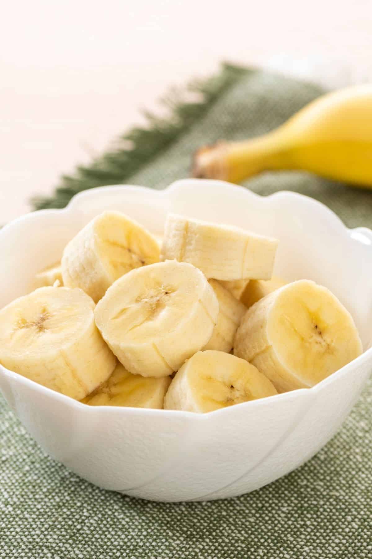 Small white bowl of sliced banana.