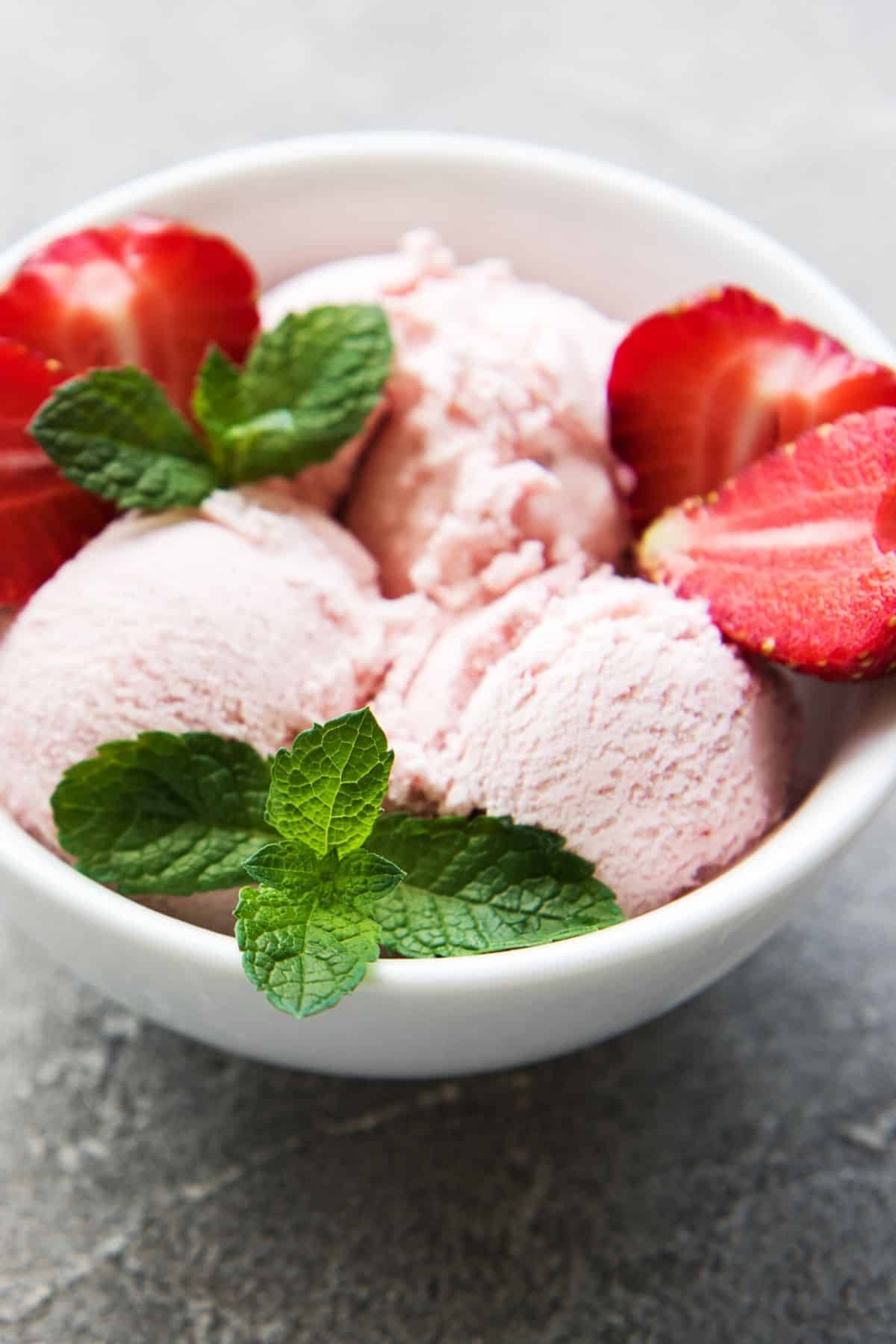 bowl of strawberry ice cream with mint.