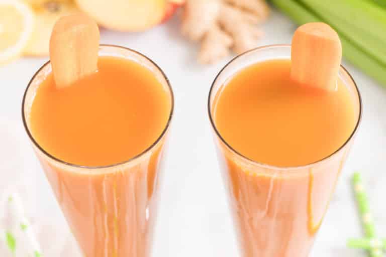 Two glasses of fresh made carrot celery juice.