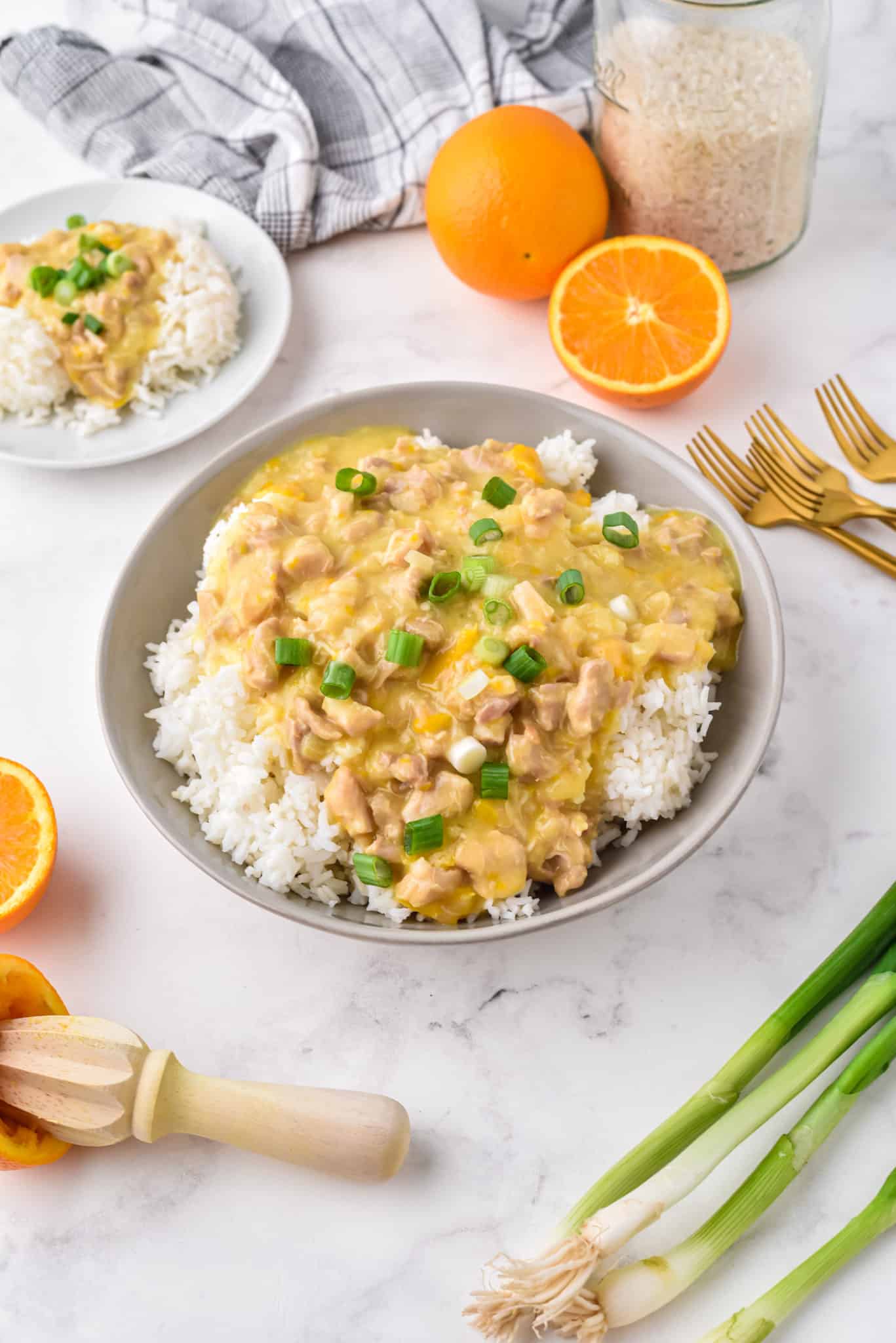 Instant Pot orange chicken over white rice in a large gray bowl.