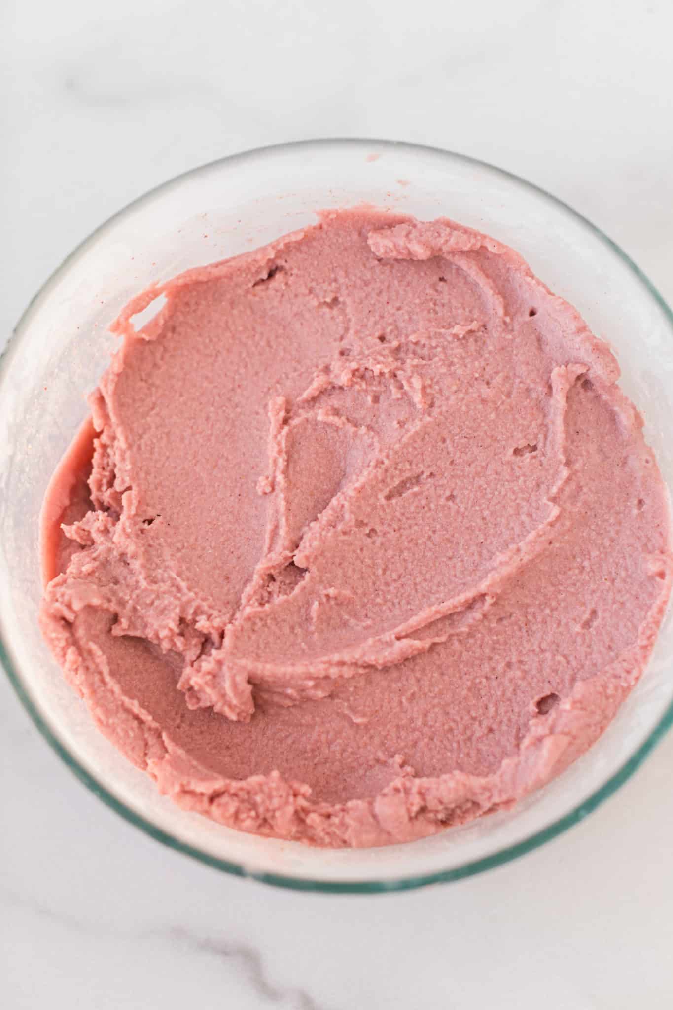 frozen vegan strawberry ice cream in a bowl. 
