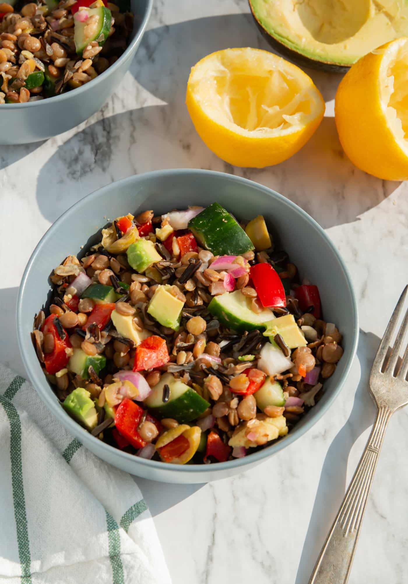 lentil and wild rice salad with chopped vegetables on a tabletop.