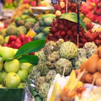 many of the best asain fruits grouped together at a market.
