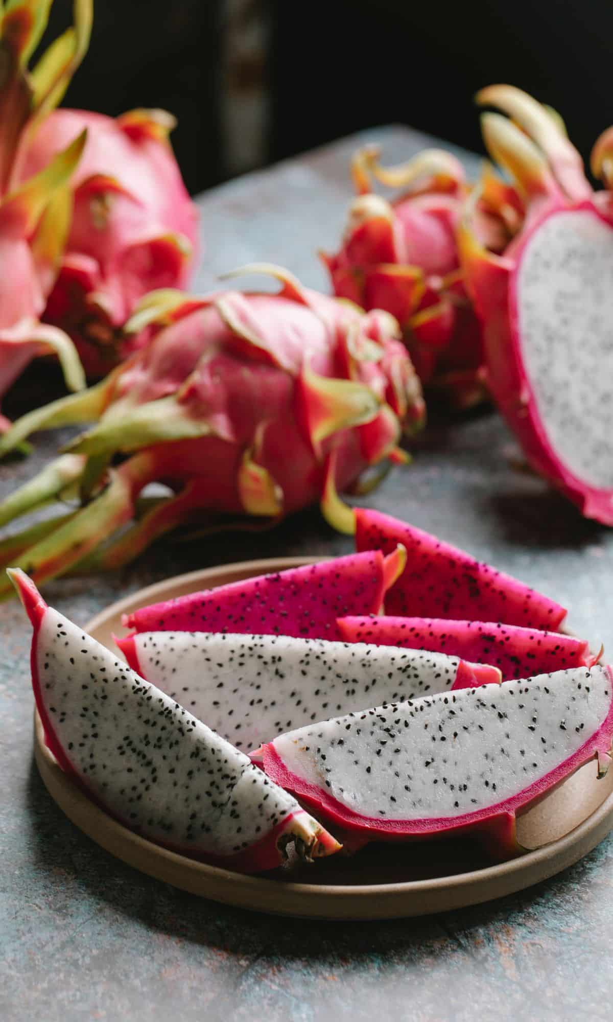 one of the best asian fruits, dragon fruit, sliced and on a brown plate.