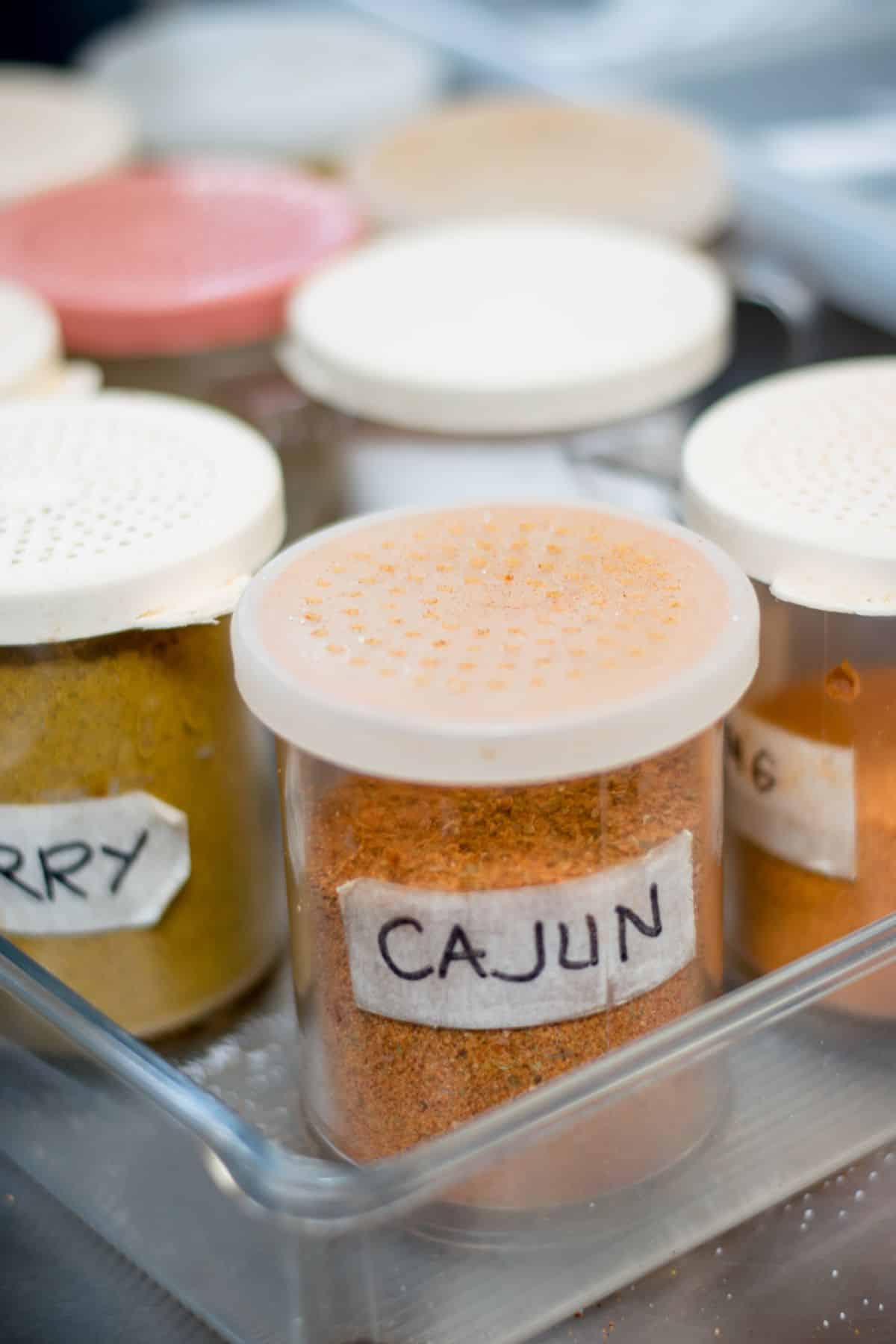 Cajun seasoning container on spice rack.